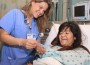 Yvonne Barbato, RN, helps prepare Maria Hassan, 19, for surgery to correct drooping eyelids.