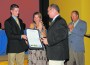 Tyler Kalbac receives award from Palmetto Bay Mayor Eugene Flinn as mom, Beth, and dad, Dan, watch proudly.