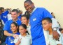 Marlins president David Samson (left) and vice president-general manager Michael Hill are pictured with some of the children who received toys.