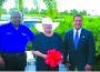From left to right Florida City Mayor Otis Wallace, Seeds to Feed Haiti Founder Margie Buster, and Homestead Mayor Steven Bateman gather together for the first shipment of vegetable seeds to Haiti.