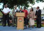 Before distributing the turkeys, community leaders . (L to R) Deputy Chief Adam Burden, Rep. Darryl Reaves, Rev. Jerome Starling, rapper Brisco, Mayor “Lady” Myra L. Taylor and former Opa-locka Commissioner Terence Pinder, deliver a message of Non-Violence from the podium during the opening ceremony at the “Thanksgiving for Life” Give-Away.