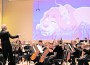 Eduardo Marturet conducts the Miami Symphony Orchestra in a concert of Disney music while images from Disney classics are project above the orchestra.