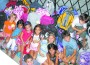 Youngsters pose with some of the backpacks they put together for Angel Share.