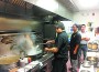 Yony Moy (right) watches over his kitchen at Wok Masters.