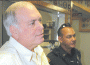 Chief of Police Orlando Martinez de Castro (left) and Officer W. Ralph Baumer observe as Sergeant Rich James explains the new secure evidence locker capabilities.