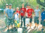 Trash Team#1 takes a quick break with trash in hand.