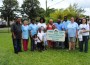 Members of the Community Relations Recreation & Activities Advisory Board stand with Mrs. Angela Dixon and her Family on her beautiful green Lawn. (L to R) City of Opa-locka Finance Director Dr. Ezekiel Orji, Ms. Jacqueline Fogarty, Mr. Jannie Russell, Commissioner Rose Tydus, Winner -Mrs. Angela Dixon and her Son - Edward Brice, Deacon Eugene Stanley, Ms. Linda Parker, City Manager Bryan Finnie, Ashley Rivera, along with young Destiny, C.J., and the grandchildren of Mr. & Mrs. Dixon