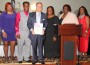Corporate Humanitarian Award recipient Alex Gonzalez of Waste Management flanked by Rhonda and Alvin Miller, Commissioner Gail E. Miller. Regina Miller and Debra Sheffield-Irby.