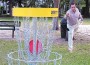 Miami Disc Golf Association president George Alvarez scores a basket.