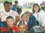 Miami-Dade County Commissioner Lynda Bell is pictured with some of the children who received backpacks.