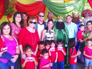 Pictured at center are Mercy Hernandez (with sunglasses) and Irma Gomez of the EDGE Foundation; behind themare (l-r) Zulema Cruz and Maridaliz Matta of Payless ShoeSource and Mayor of Humacao, Marcelo Trujillo, and a
member of his staff; between the Three Kings is State Rep. Narden Jaime.