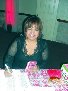 Dr. Iris Torres collects $15 gift cards from members. The cards were distributed to the more than 100 children served by the club’s May Van Sickle Dental Clinic as a holiday gift.