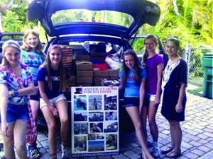  Pictured with the boxes they packed are (l-r) Lisa Amore, Victoria Harris, Julia Richardson, Meredith Flinn, Claire Landon, and Sydney Howard.