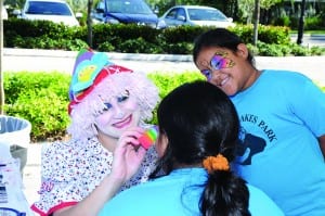 Jennifer and Scarlett Irias enjoy having their faces painted by a clown at the MCH Midtown OutpatientCenter’s grand opening event.