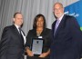 JCS Chair Elect Dan Jacobson (left) and JCS President/CEO Fred Stock congratulate employee Bridget Cross on 25 years of service