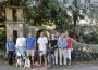 High Pines residents are planning to save, rebuild and restore the distinctive and historic native coral rock arches that define their neighborhood; the pillars are presently in various stages of disrepair. Pictured from left: J.T. Rawlins, T.K. Heatley, James Heatley, Austin Matheson, Suzanne Martinson, Elizabeth Smith, Henry Matheson and Susan Heatley are among the project's grassroots organizers. Brittany Spaniels Lucy and Slater Heatley manage "community outreach!"