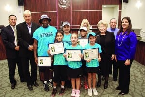Young village tennis players honored for competition win