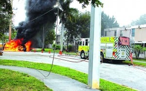 Fire engulls cars next to After School House