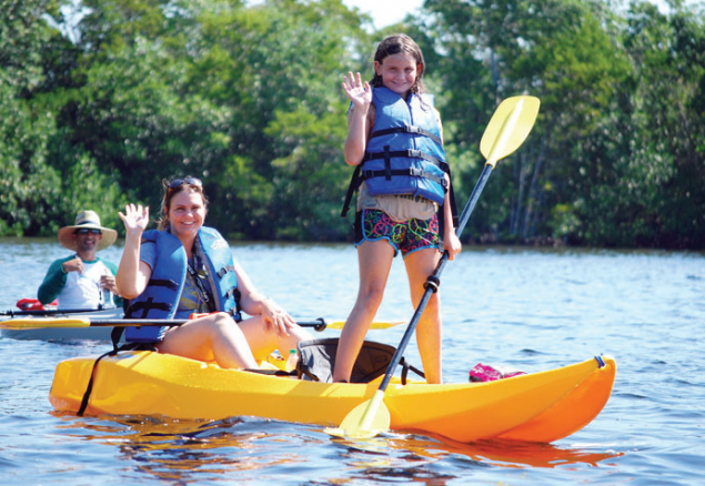 Kaitlyn Steele (standing) joins her mother, Jessica Steele, in the kayak eco-tour. In the background is David Cordero, one of the tour guides for Nature Postings. (Photo by Bill Kress)