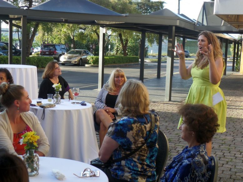 National Association of Professional Women Miami President Aly Ramos addresses NAPW members at recent meeting hosted by Victoria’s Collection.