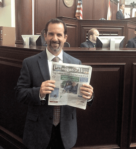 State Rep. Michael Bileca, whose legislative district includes Palmetto Bay, holds a copy of the Palmetto Bay News while standing on floor of the Florida House of Representatives in Tallahassee.
