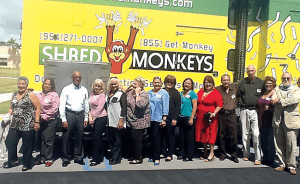 Pictured are attendees at the meeting, gathered in front of the shredder truck.