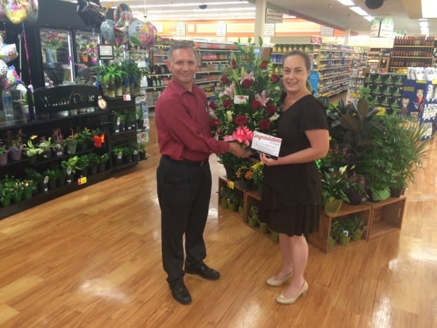 Miami Winn-Dixie store No. 249 Store Director Carlos Ortega and Great Grocery Giveaway winner Michelle Queen. 
